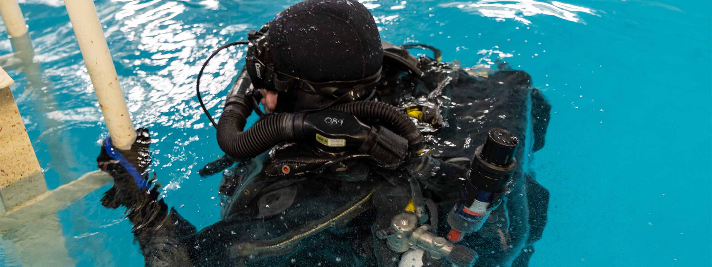 A diver surfaces from the water