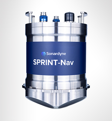 A cylindrical Sonardyne SPRINT-Nav device, metallic silver with a blue band featuring the brand name and product model, shown against a light gray background.
