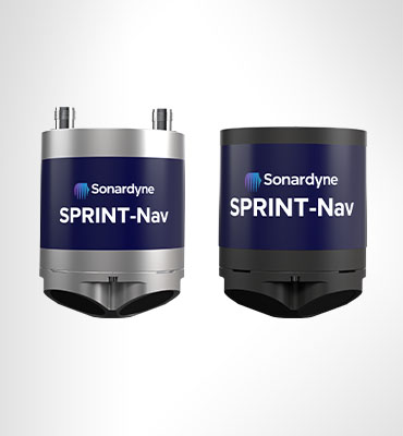 Two cylindrical Sonardyne SPRINT-Nav devices. The left device is silver and dark blue, with two connectors on top. The right device is black and dark blue.