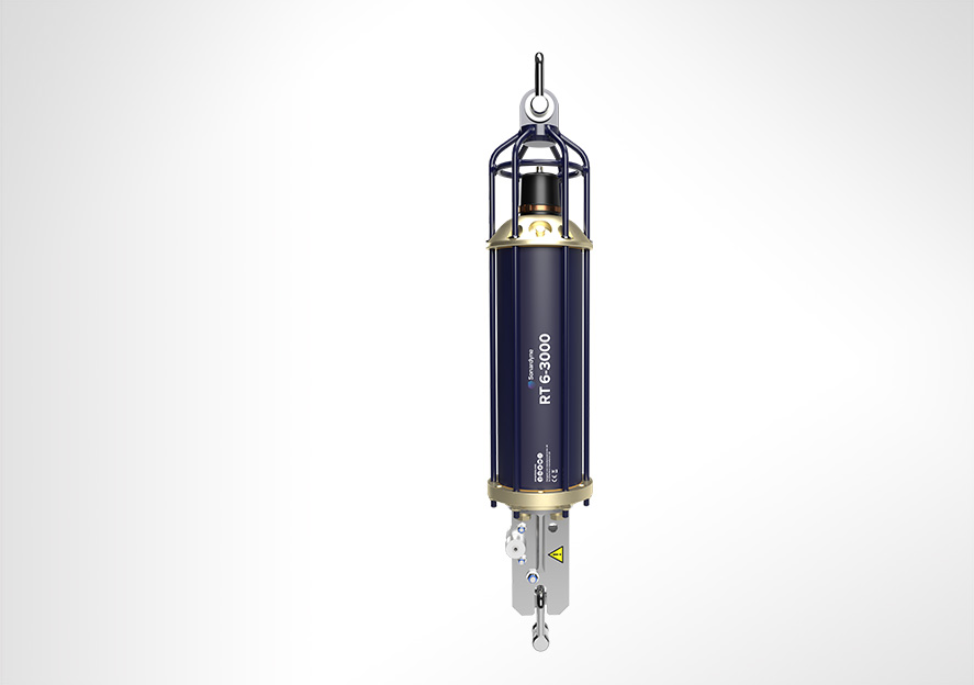 A Sonardyne RT 6-3000 device, dark blue and silver, suspended vertically against a light gray background.