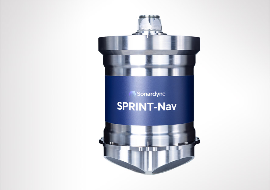 A silver cylindrical Sonardyne SPRINT-Nav device with a blue label, featuring four oval openings at the bottom.