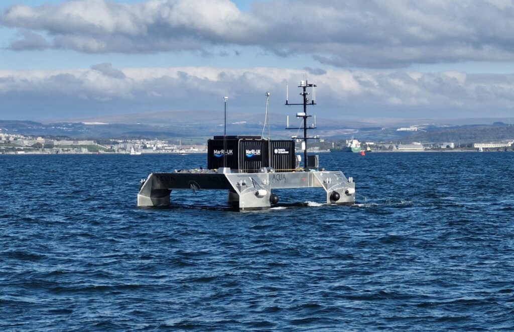 ACUA Ocean's PIONEER USV at sea near a coastline.